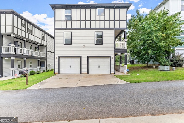 view of front of house with a front lawn, a balcony, and a garage