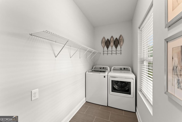 clothes washing area featuring washing machine and dryer and tile patterned floors