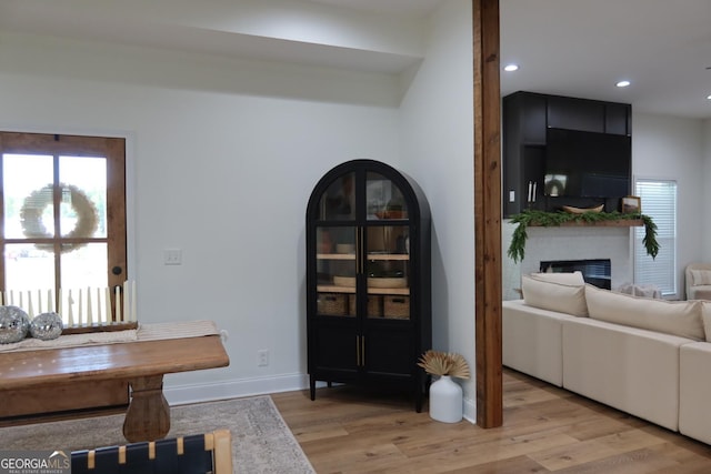 dining area with light hardwood / wood-style floors and a large fireplace