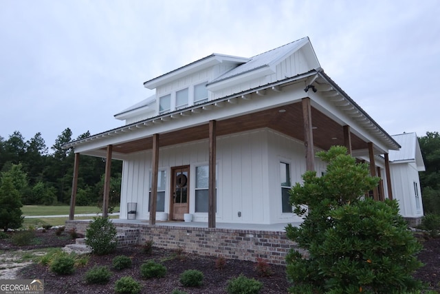 view of side of home with a porch