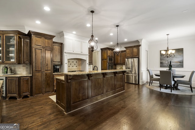 kitchen with pendant lighting, dark hardwood / wood-style flooring, tasteful backsplash, and stainless steel refrigerator with ice dispenser