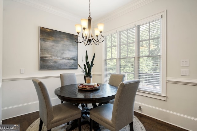 dining area with a notable chandelier, crown molding, and dark hardwood / wood-style flooring