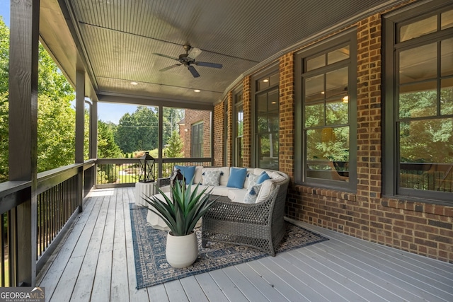 deck with ceiling fan and outdoor lounge area