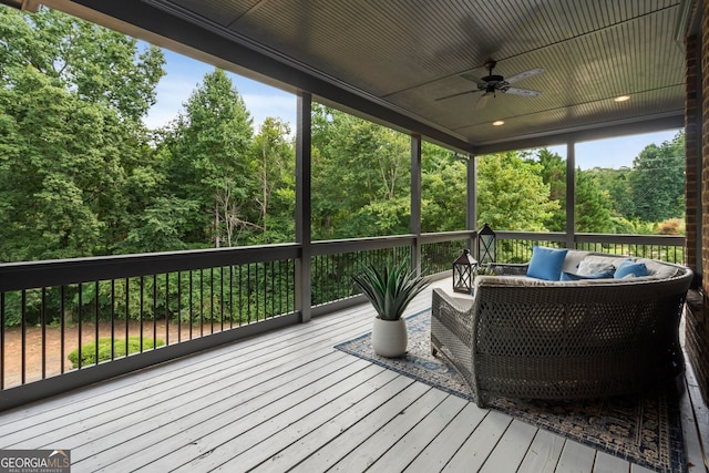 wooden terrace featuring ceiling fan and outdoor lounge area