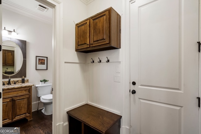 bathroom with crown molding, wood-type flooring, toilet, and vanity