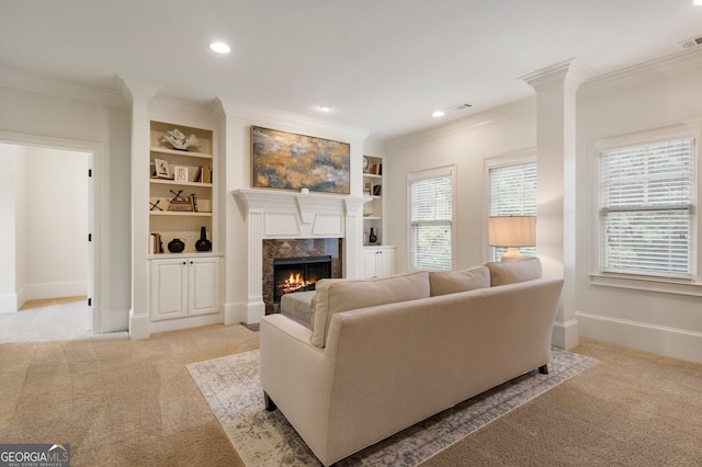 carpeted living room with ornamental molding, a high end fireplace, and built in features