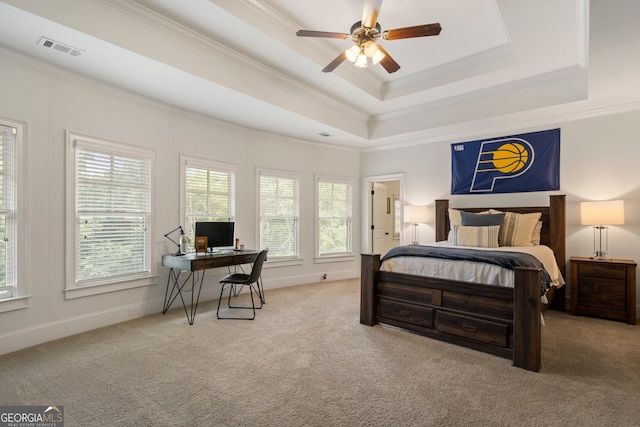 carpeted bedroom featuring ceiling fan, a raised ceiling, and ornamental molding