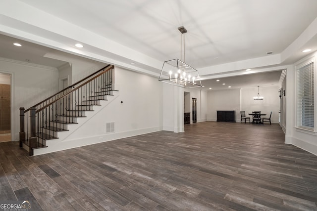 unfurnished living room featuring dark hardwood / wood-style floors and a chandelier