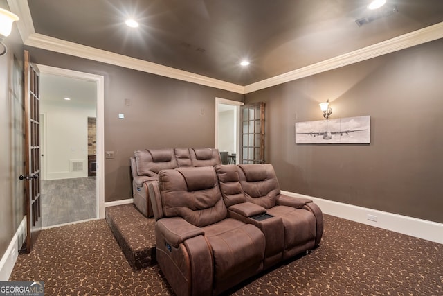 carpeted cinema room with ornamental molding