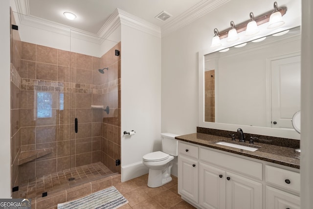 bathroom featuring vanity, tile patterned flooring, crown molding, tiled shower, and toilet