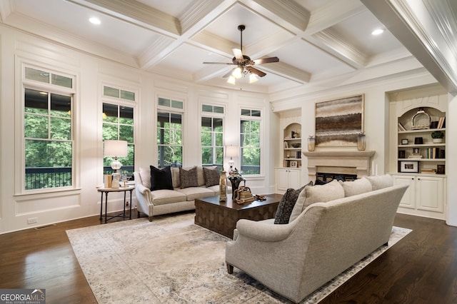 living room featuring coffered ceiling, dark wood-type flooring, plenty of natural light, and built in shelves