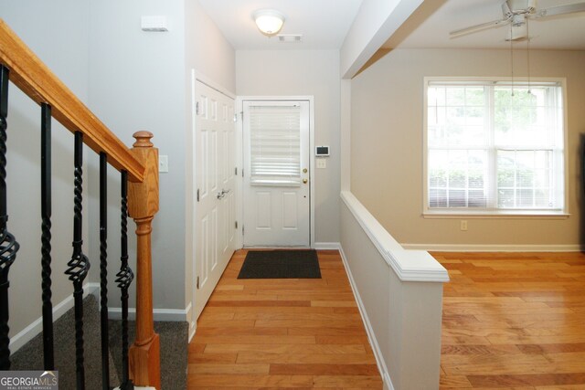 entrance foyer with ceiling fan and light hardwood / wood-style flooring