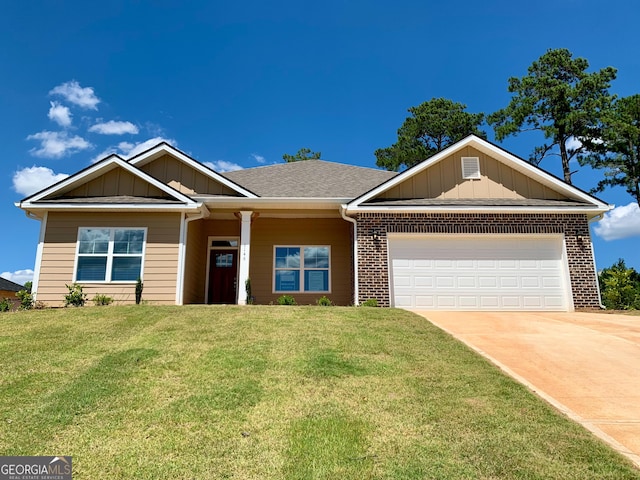 view of front of house with a front yard and a garage