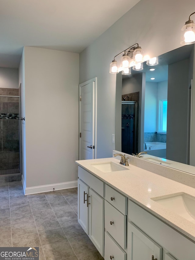 bathroom featuring plus walk in shower, vanity, and tile patterned flooring