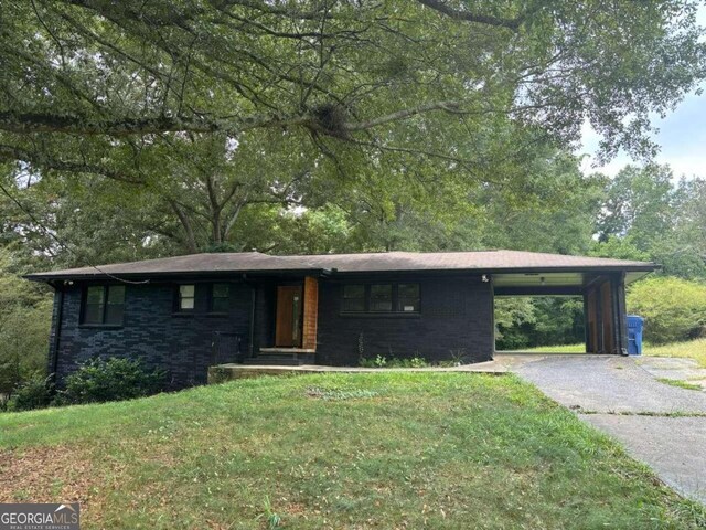 view of front of house featuring a carport and a front lawn