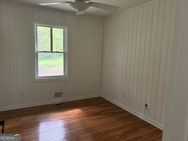 spare room featuring ceiling fan and dark hardwood / wood-style floors