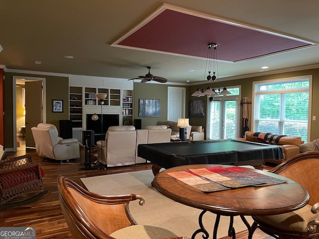 recreation room with built in shelves, crown molding, pool table, dark hardwood / wood-style floors, and ceiling fan