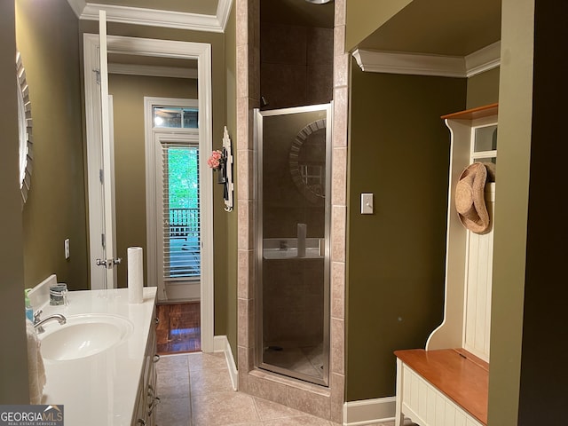 bathroom with vanity, an enclosed shower, tile patterned floors, and crown molding