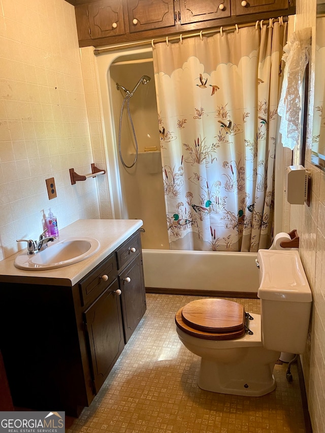 bathroom featuring tile walls, toilet, vanity, and tile patterned floors