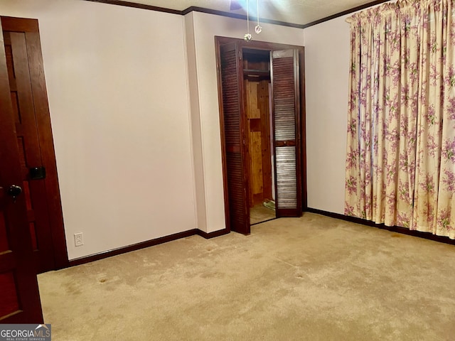 carpeted spare room with ornamental molding