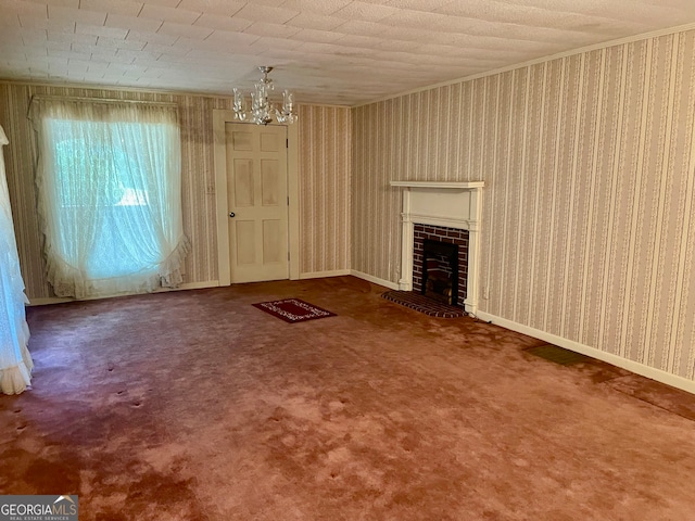 unfurnished living room featuring a brick fireplace, an inviting chandelier, and carpet