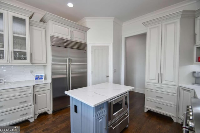 2771 Point Overlook, Gainesville, GA 30501 - kitchen with tasteful backsplash, white cabinets, a center island, built in appliances, and light stone counters