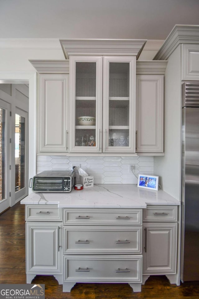 2771 Point Overlook, Gainesville, GA 30501 - bar with stainless steel refrigerator, white cabinetry, backsplash, dark hardwood / wood-style floors, and light stone counters