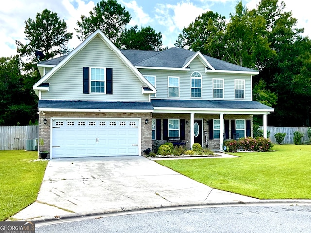 view of front of home with central AC unit, a garage, and a front lawn