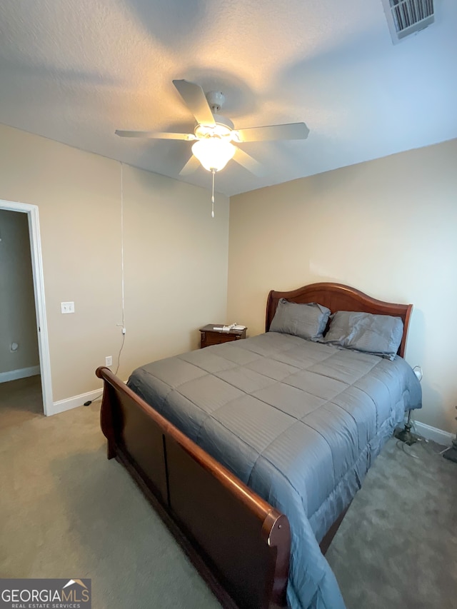 carpeted bedroom with ceiling fan