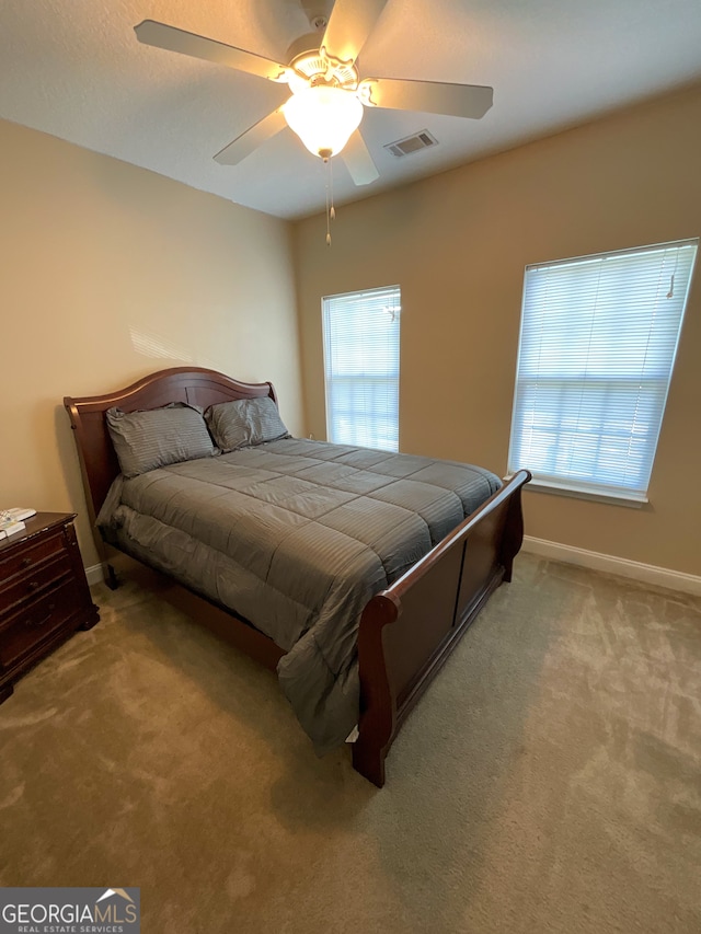 carpeted bedroom with ceiling fan