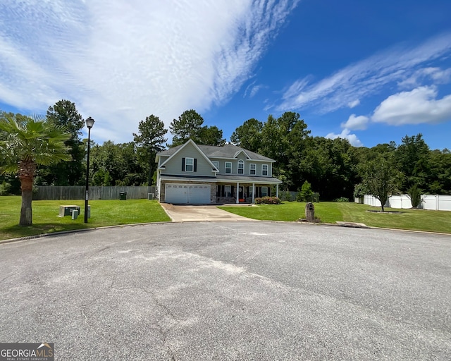 view of front of property featuring a front lawn and a garage