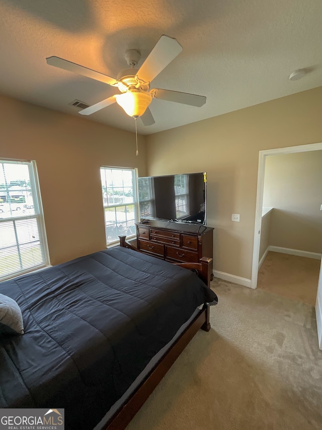 bedroom with ceiling fan and carpet floors