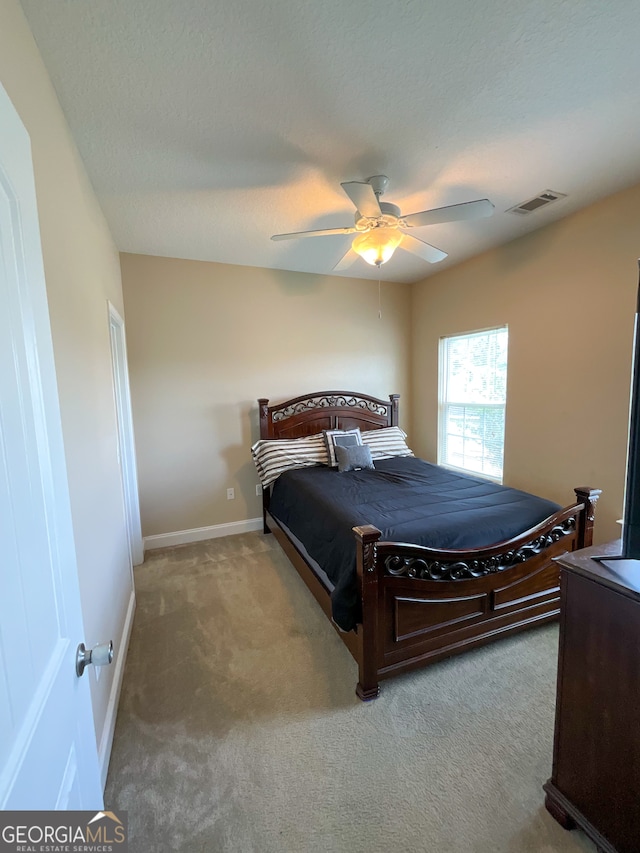 bedroom featuring ceiling fan and light colored carpet