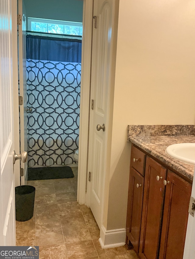 bathroom with tile patterned floors and vanity