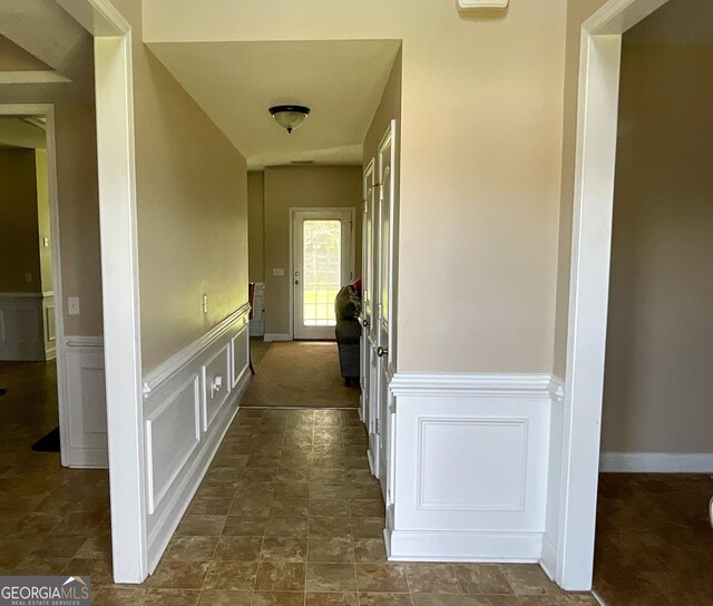 corridor featuring dark tile patterned floors