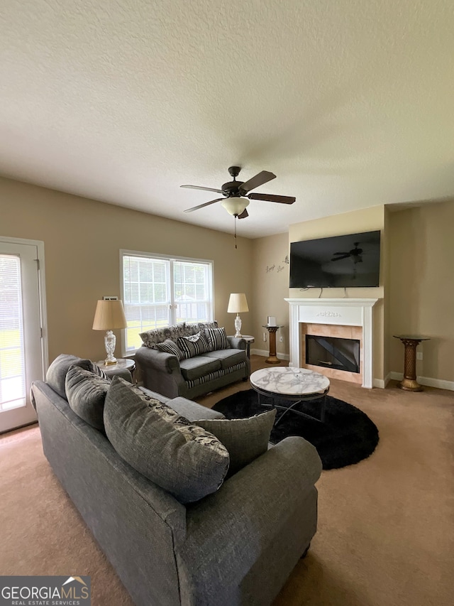 living room featuring a fireplace, plenty of natural light, ceiling fan, and carpet flooring