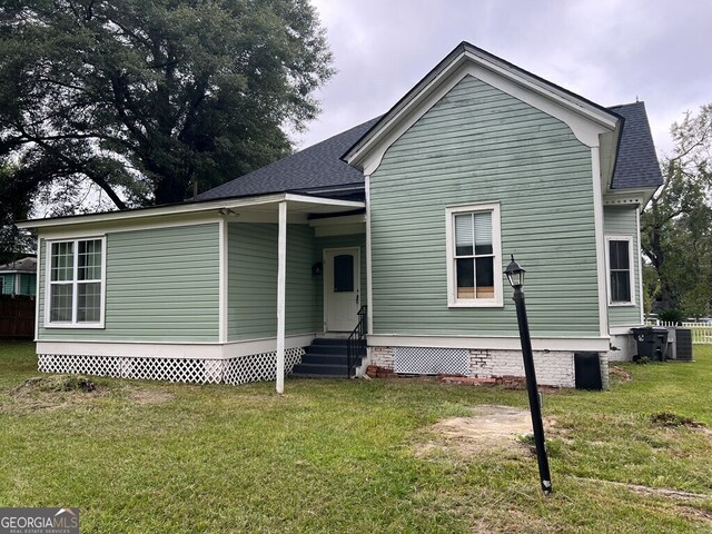 exterior space with cooling unit and a front yard