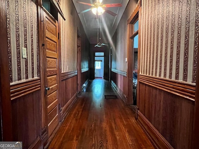 corridor featuring lofted ceiling and dark hardwood / wood-style floors