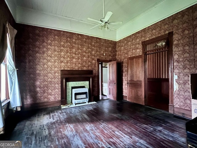 unfurnished living room featuring ceiling fan, wood-type flooring, a fireplace, and a high ceiling