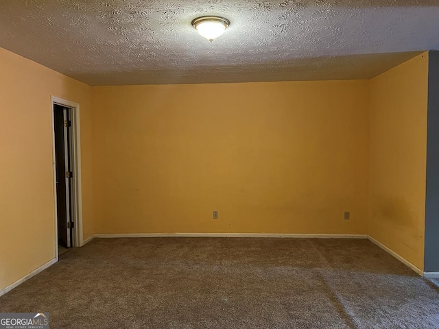 carpeted empty room with a textured ceiling