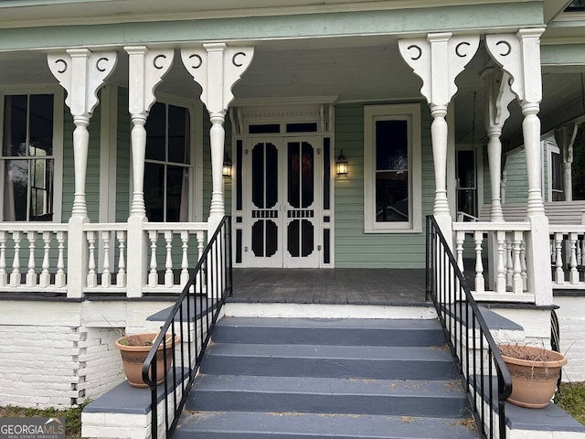 view of exterior entry featuring a porch