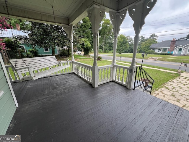 wooden deck featuring a yard