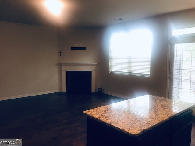 unfurnished living room with dark wood-type flooring