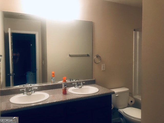 full bathroom with vanity, tub / shower combination, and toilet