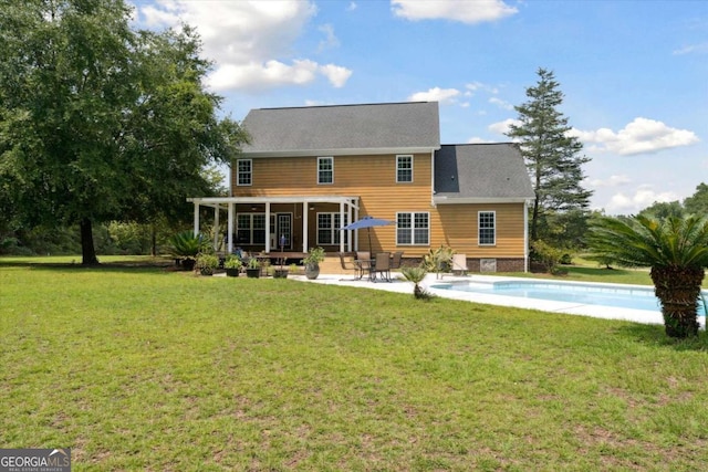 back of house with a patio and a yard