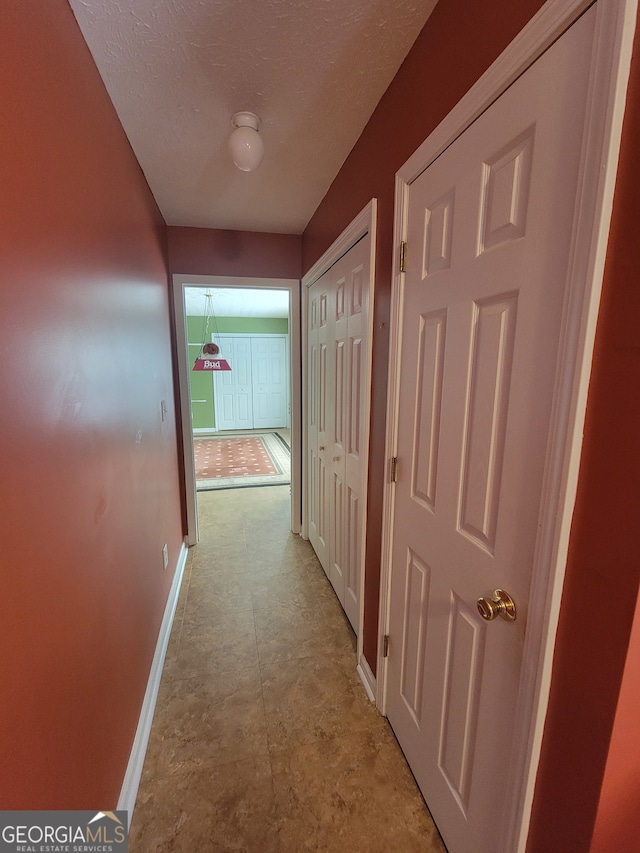 hall with light tile patterned floors