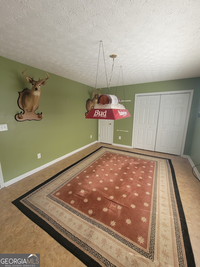 game room featuring a textured ceiling