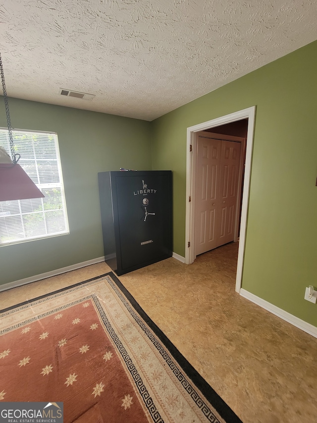 unfurnished bedroom featuring light tile patterned floors and a textured ceiling