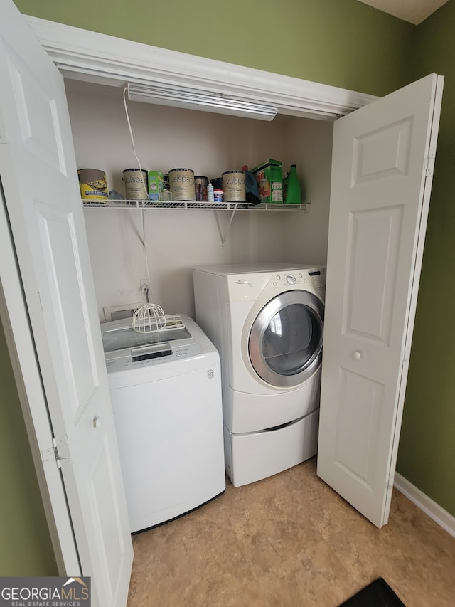 laundry room with light tile patterned floors and separate washer and dryer