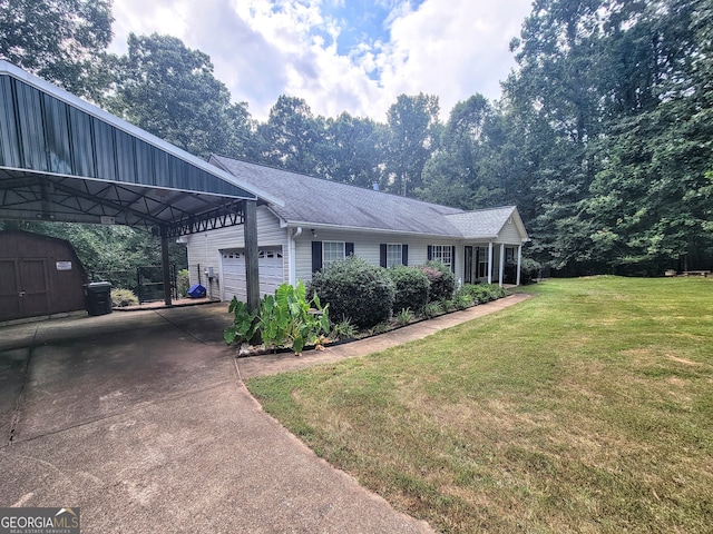 ranch-style home with a front yard, a garage, a carport, and an outbuilding